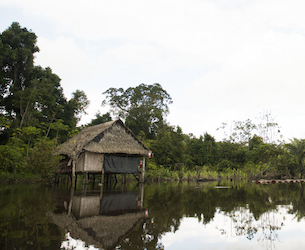 Wooden houses on stilts over a calm river